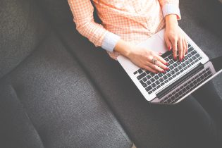 Young Caucasian Woman Typing on a Computer